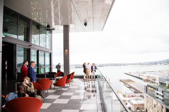 People standing and sitting at a rooftop